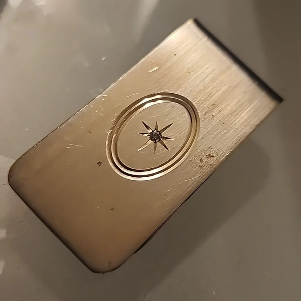 Goldtone  Money Clip With A Diamond Like Stone.